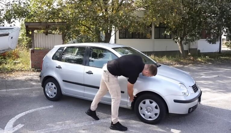 Vozač proverava automobil pre stupanja u saobraćaj